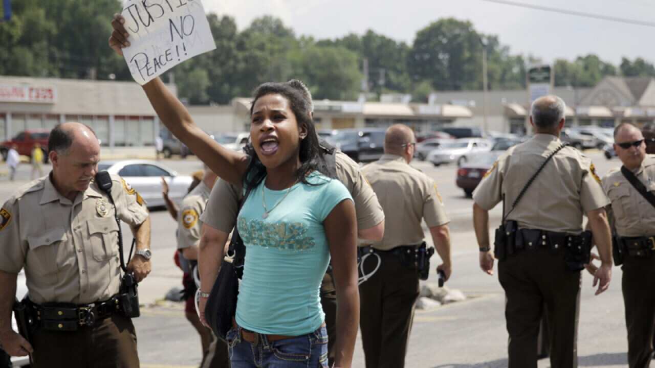 A protester holds up a sign