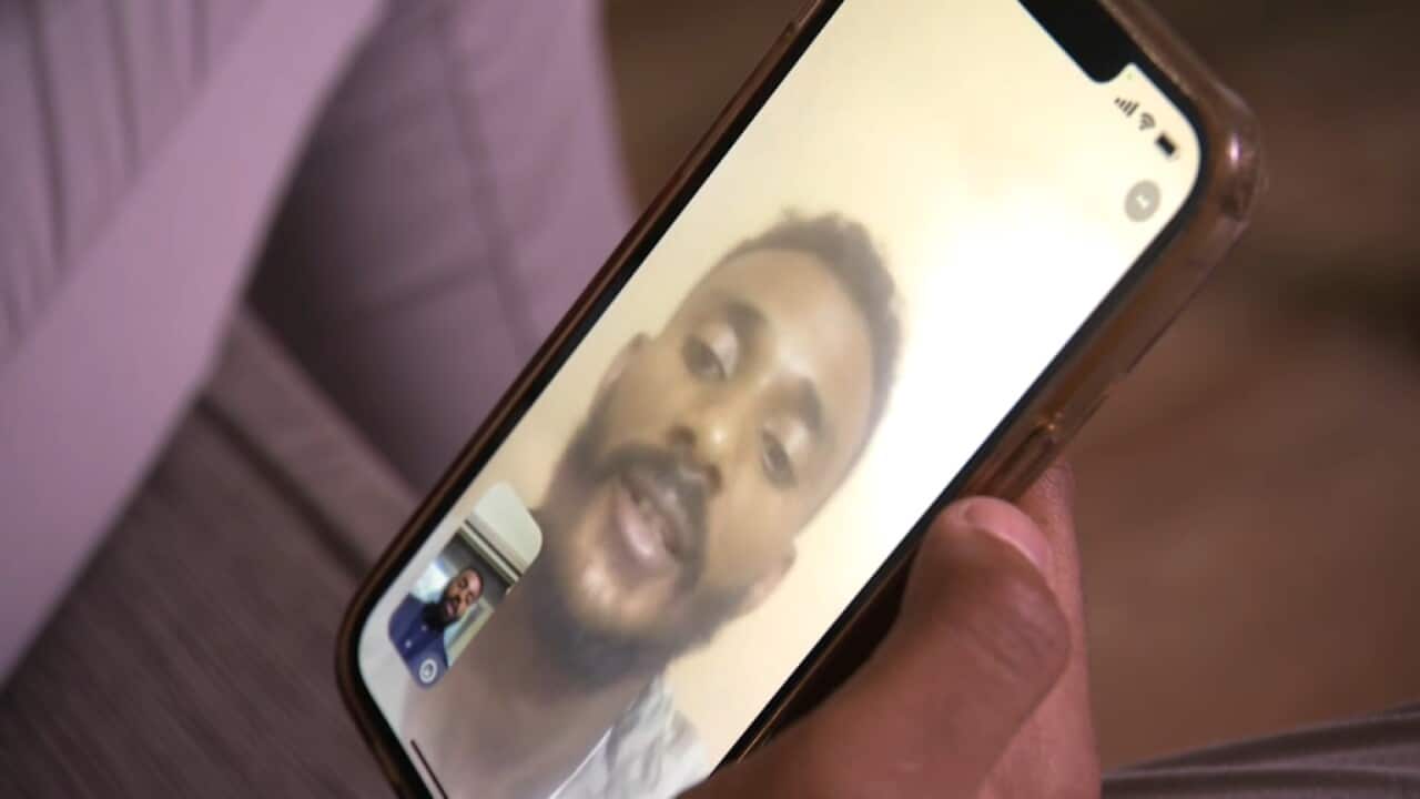 A mobile phone screen shows the video call between Mohamed Semra and his brother.