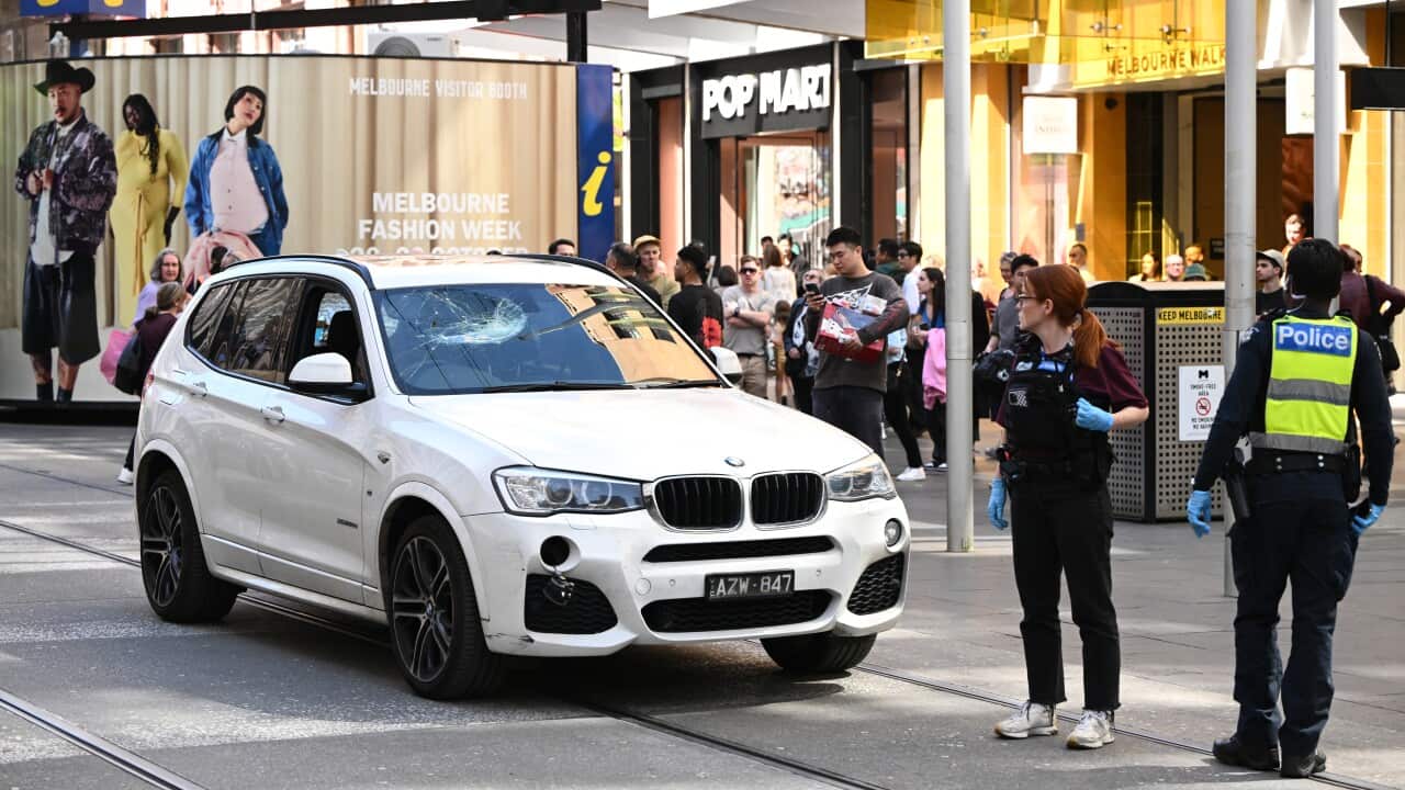 A vehicle in a shopping strip and police officers