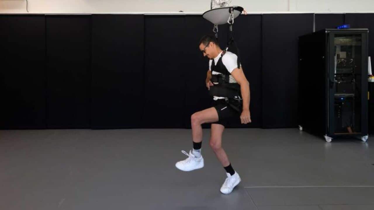 Paraplegic David M'Zee walks with the new technology