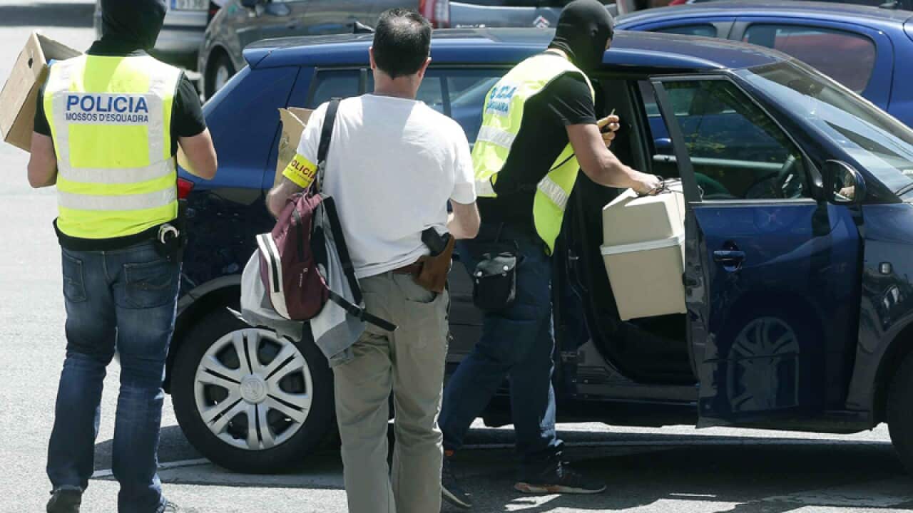 Police officers confiscate materials during a doping raid