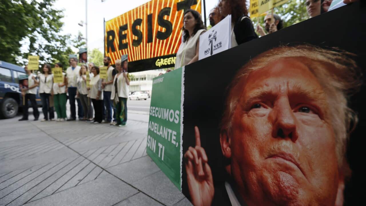 Activists shout slogans against President Donald Trump during a protest held in front of the US Embassy in Madrid, Spain.