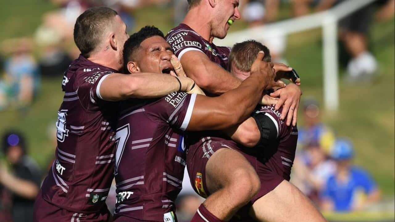 Manly Seas Eagles players celebrate a try against Parramatta Eels.