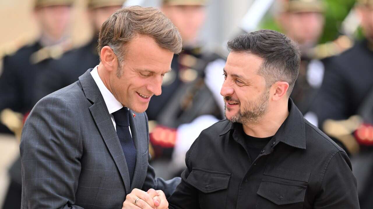 Volodymyr Zelenskyy at the Elysee Presidential Palace in Paris shaking hands