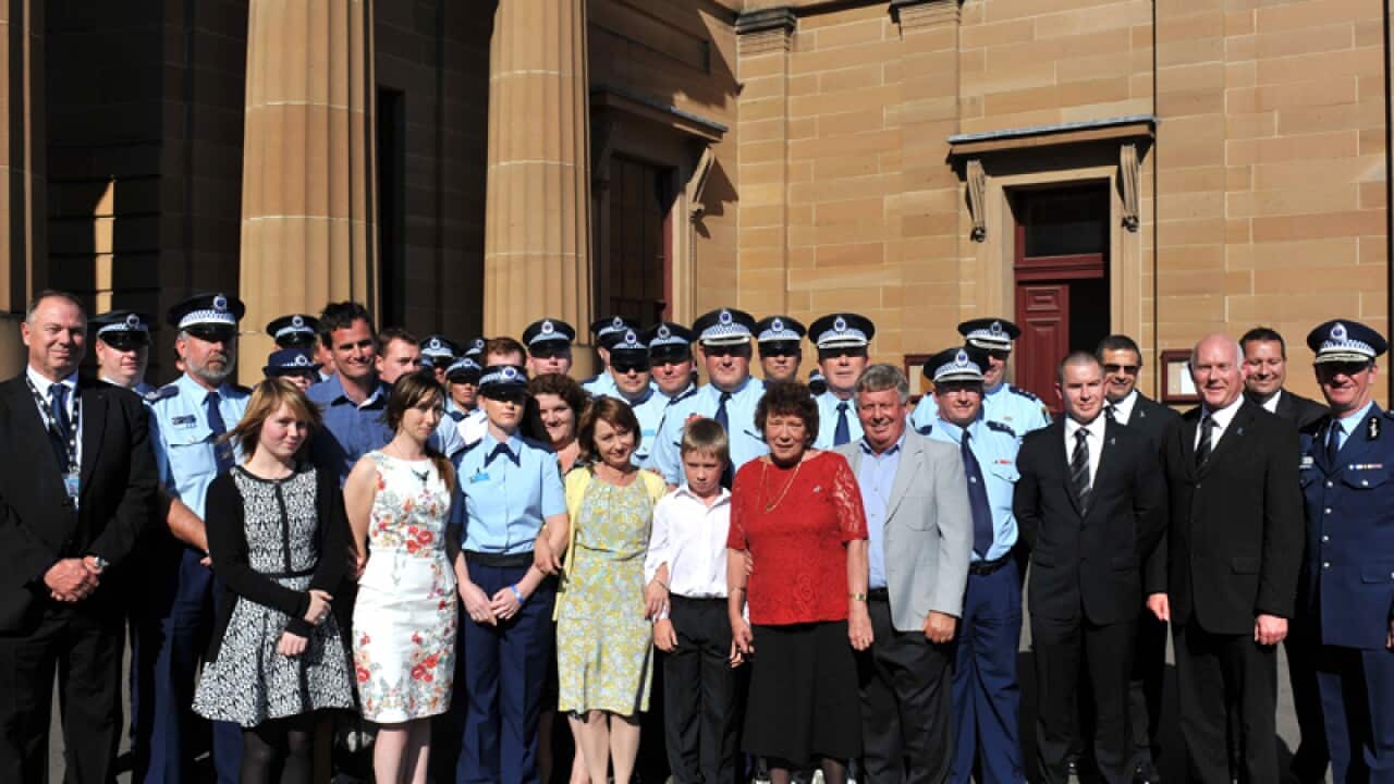 NSW policeman David Rixon's widow and children stand outside court