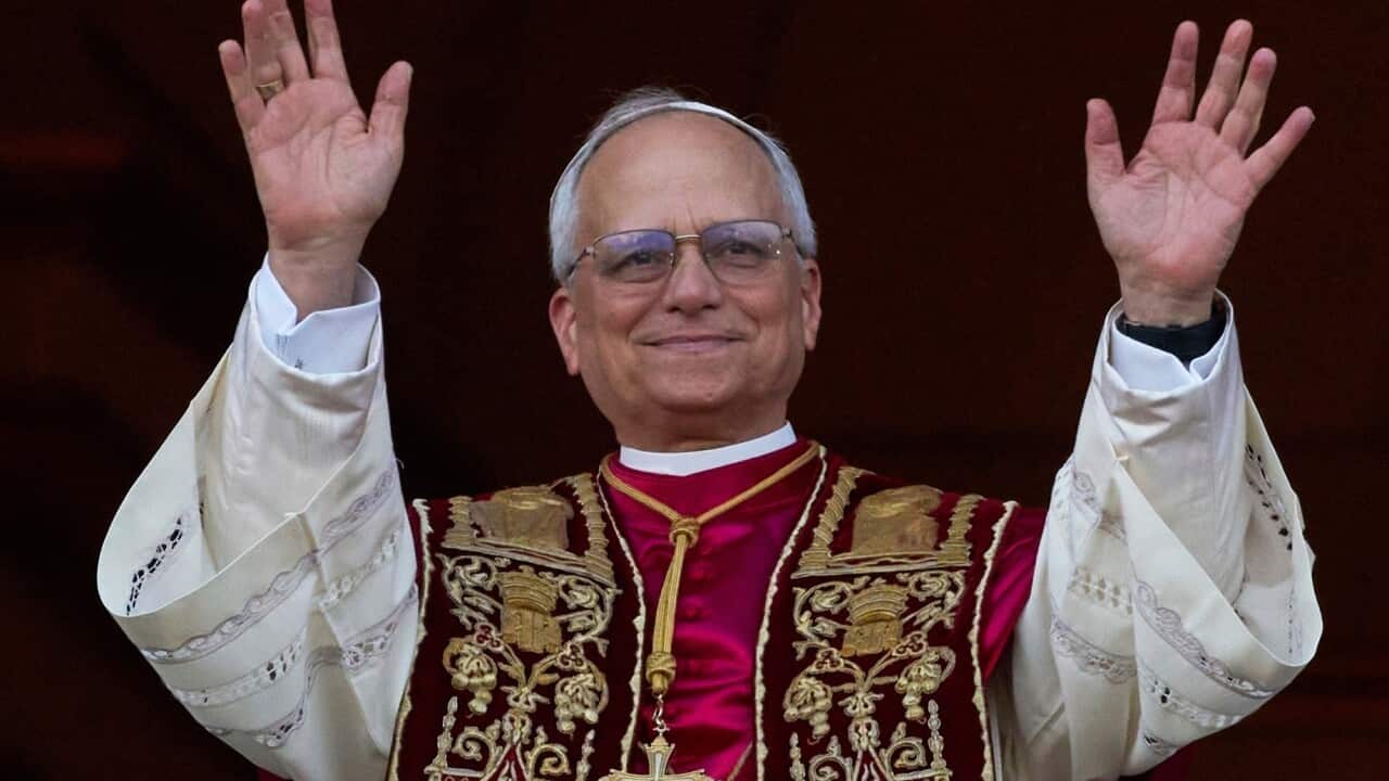 Pope Leo XIV holding up his hands.