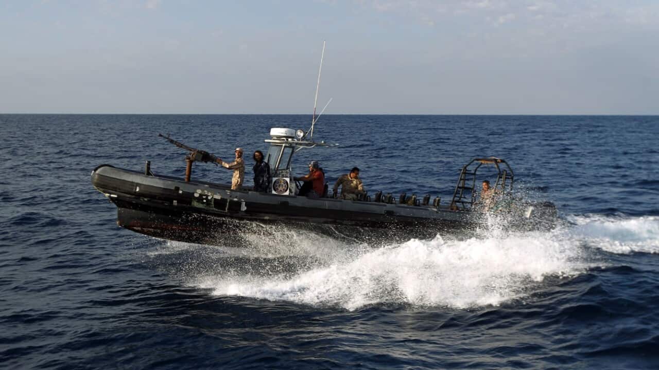 Members of Libyan naval forces on their speedboat patrol the sea