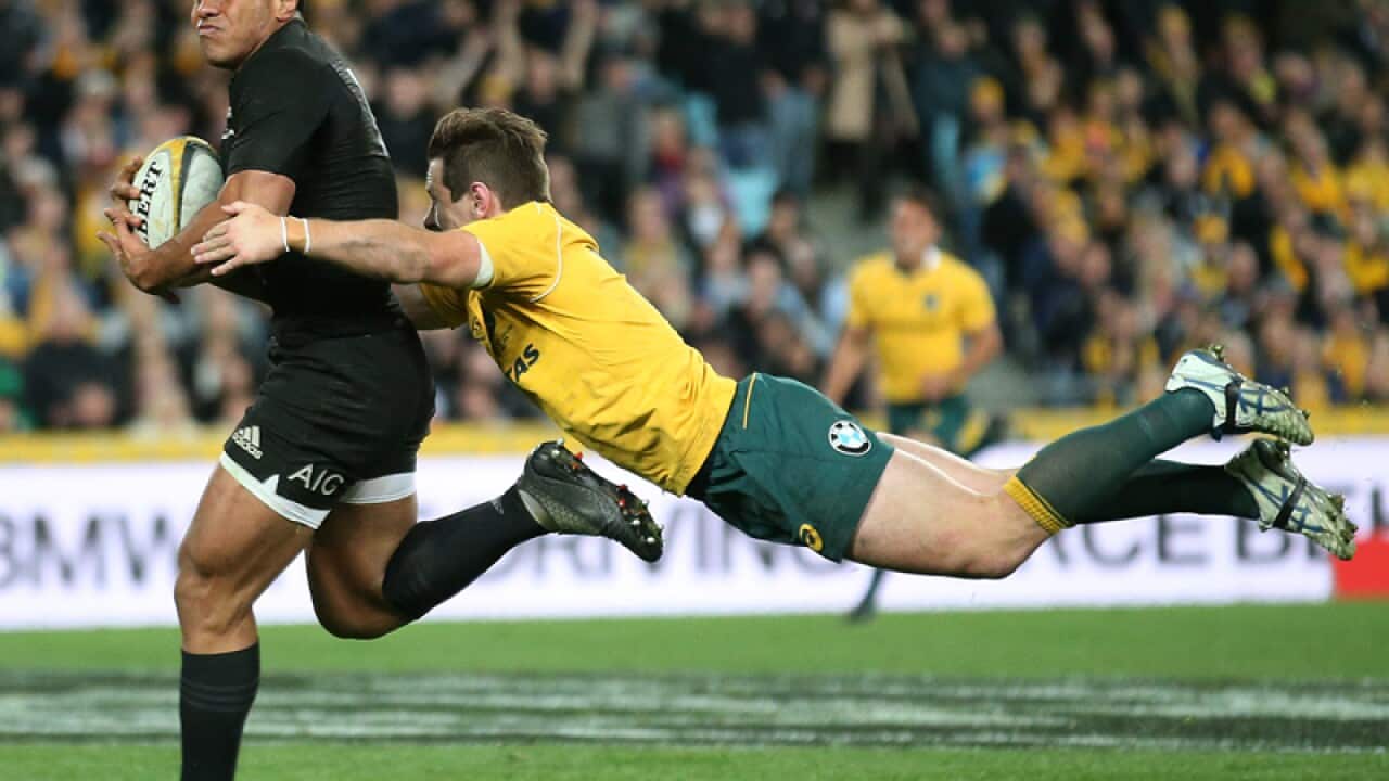 New Zealand's Malakai Fekitoa is tackled by Australia's Bernard Foley