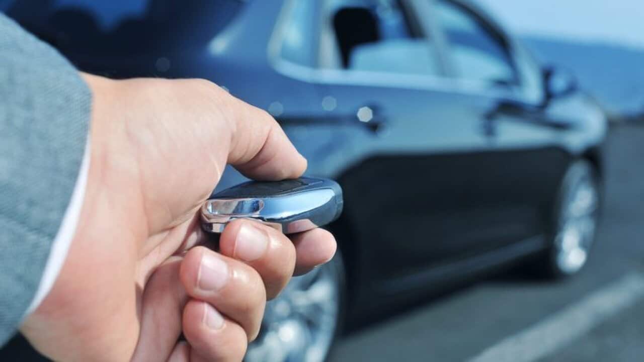 man opening his car with the control remote key