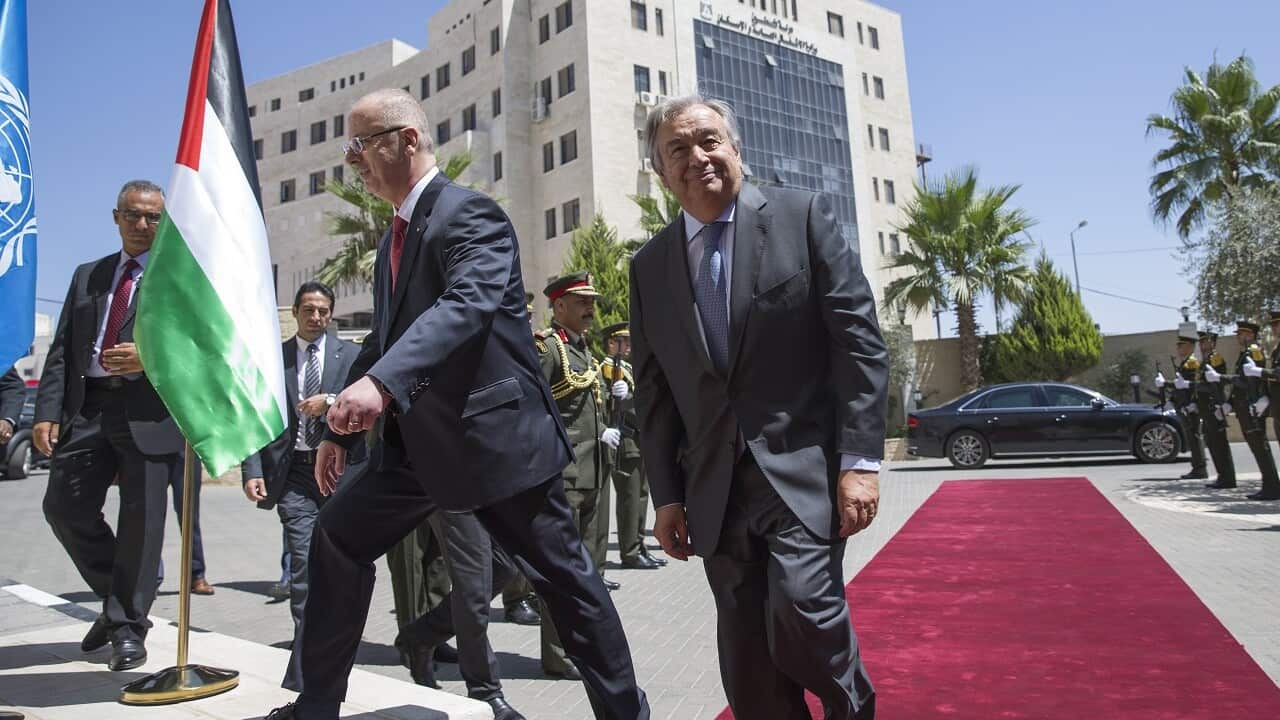 UN Secretary General Antonio Guterres (R) walks with Palestinian Prime Minister Rami Hamdallah (L) in the West Bank town of Ramallah, 29 August 2017.