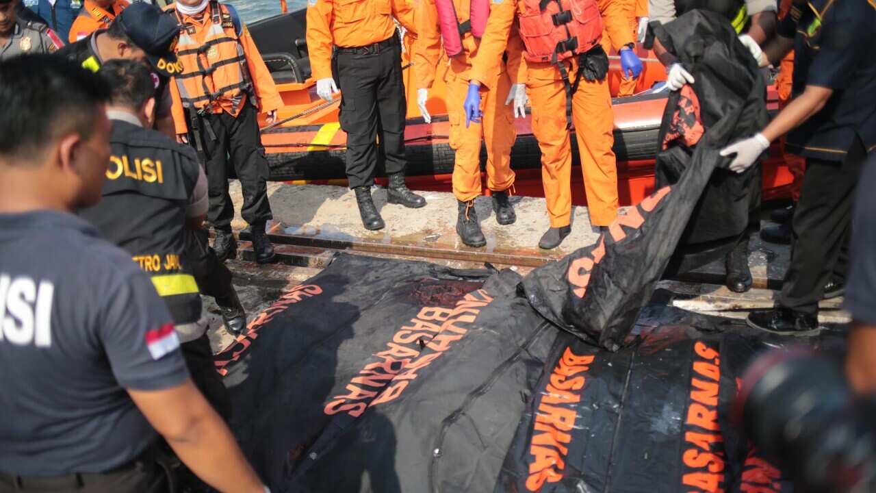 Rescue teams search for survivors from the Lion Air flight JT610.