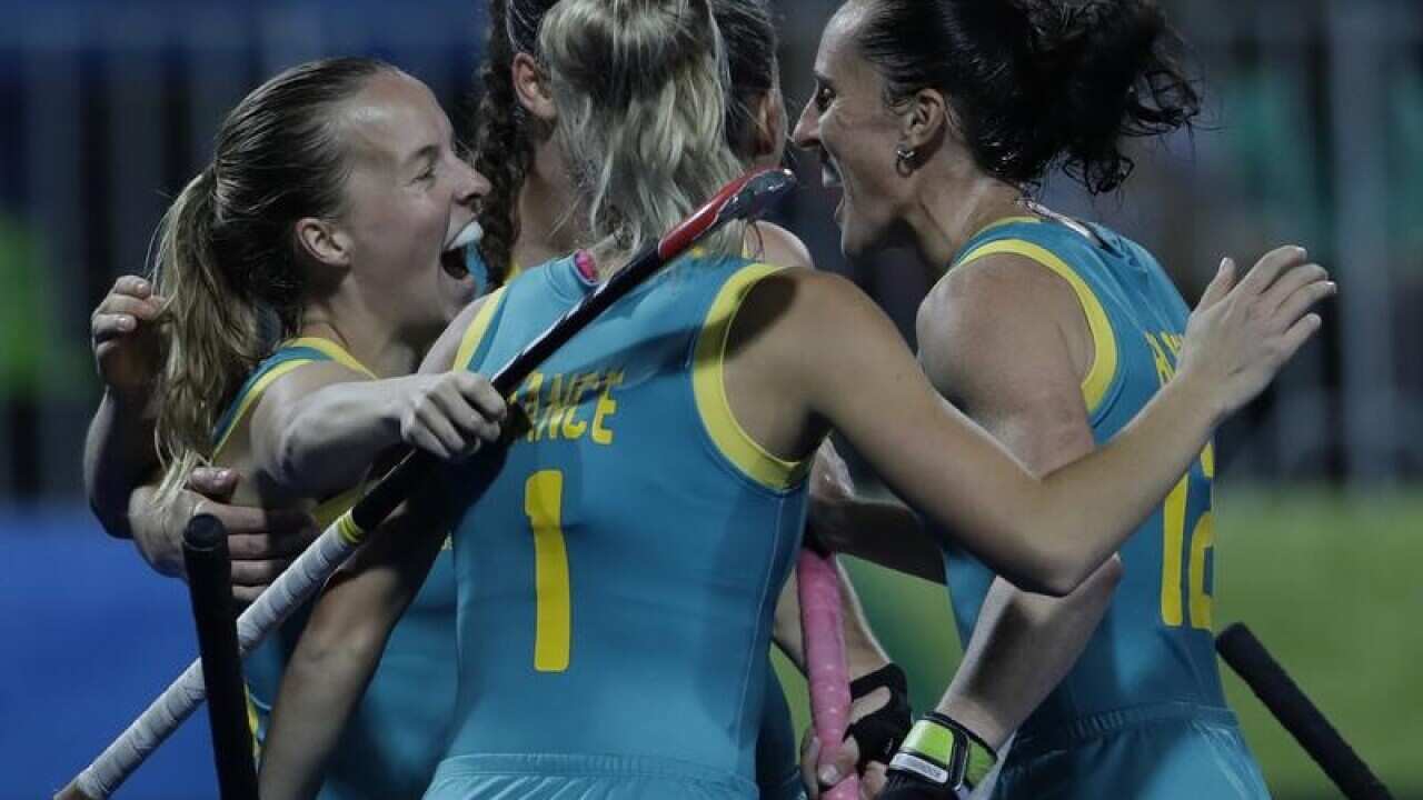 Hockeyroos player Emily Smith (L) celebrates with teammates