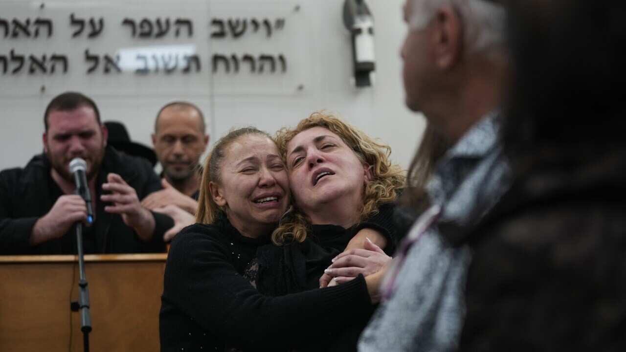 Mourners react during the funeral of Rafael Ben Eliyahu, a victim of a shooting attack Friday in east Jerusalem, at Givat Shaul cemetery in Jerusalem, Sunday, Jan. 29, 2023