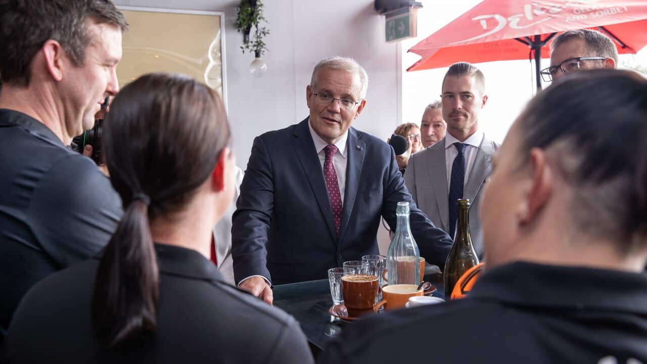 Australian Prime Minister Scott Morrison and Liberal candidate for Blair Sam Biggins during a visit to the Fourthchild Cafe Restaurant on Day 36 of the 2022 federal election campaign, in Ipswich, in the electoral division of Blair, Monday, May 16, 2022. (