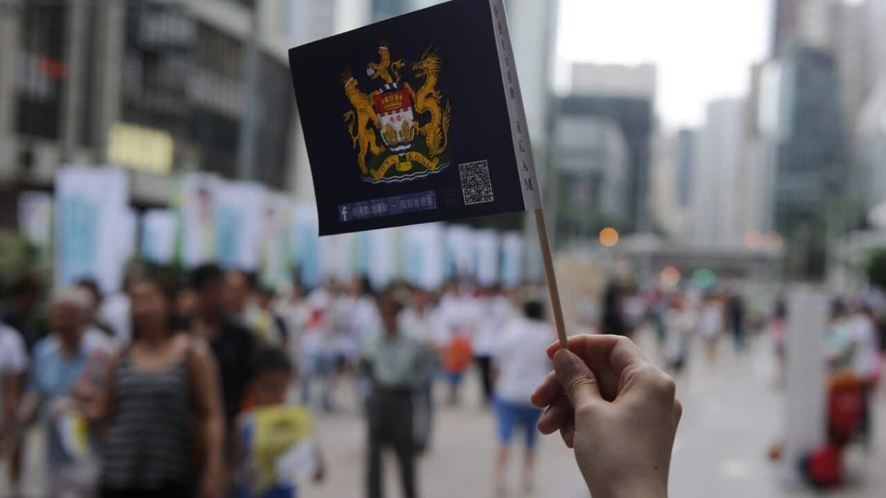 A protester holds a Hong Kong colonial-era coat of arms during a pro-democracy rally on July 1, 2014. The day marks the anniversary of Hong Kong's handover from Britain to China in 1997. (Dale De La Rey/AFP/Getty)