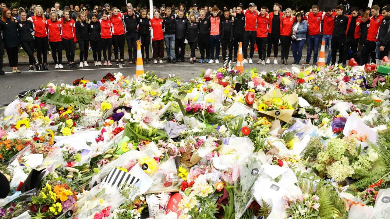 People mourn the victims of shooting rampages near the Al Noor mosque in Christchurch, New Zealand on March 17, 2019. (Kyodo via AP Images) ==Kyodo