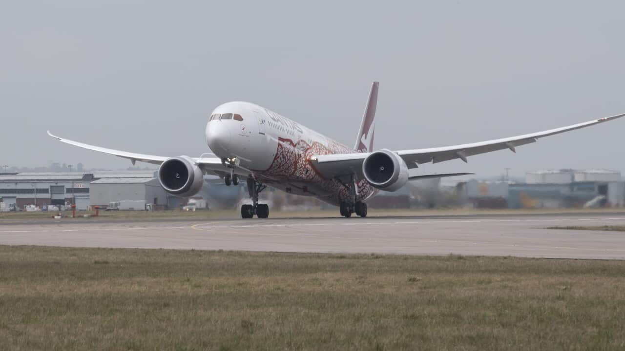 Qantas plane landing on tarmac.