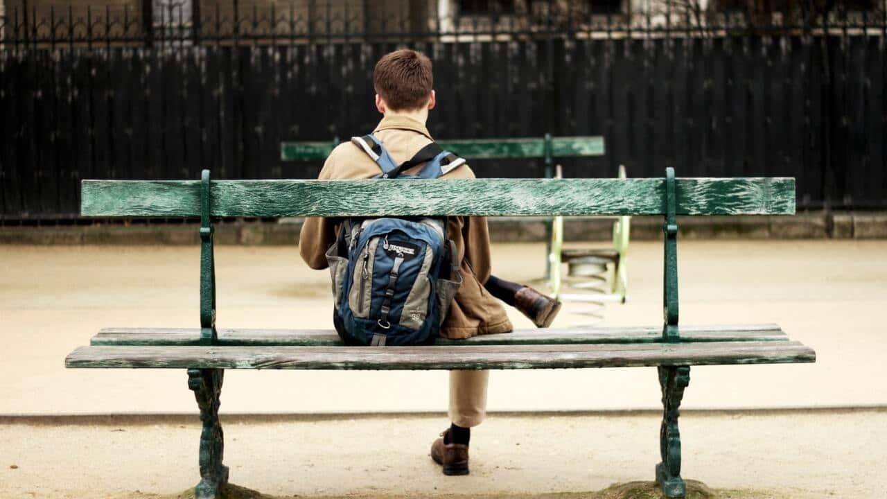 man sits alone on bench dopamine fasting