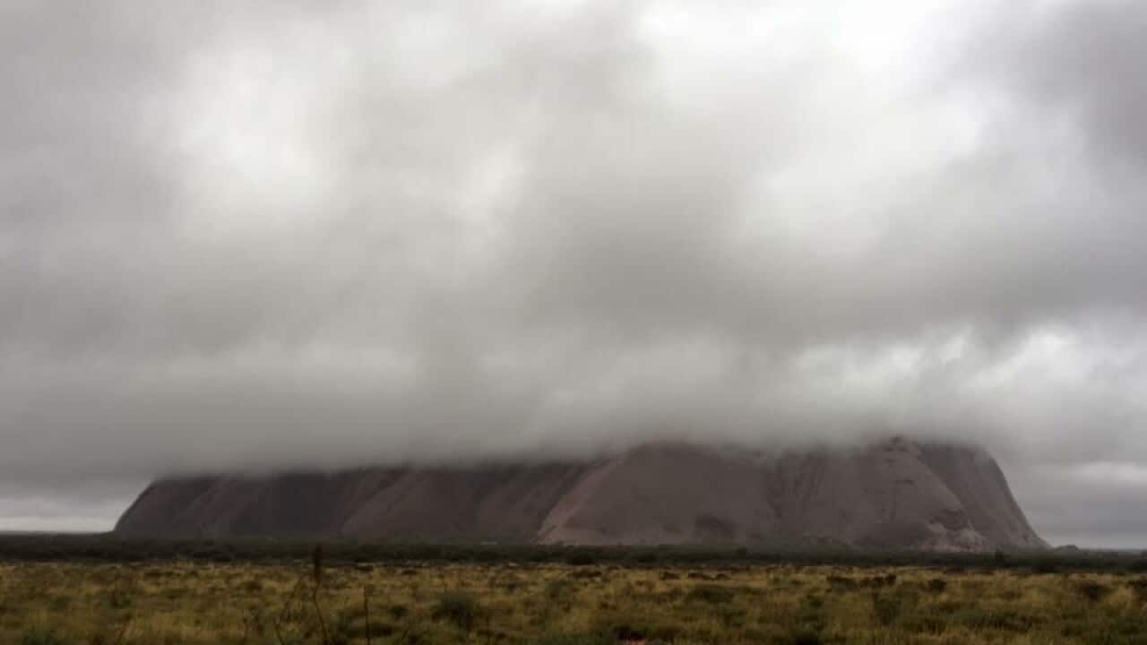A supplied image of Uluru under heavy cloud and rain on Saturday May 7, 2016. 