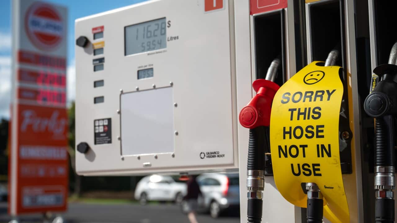 A sign saying 'sorry this hose not in use' on a petrol bowser at a service station