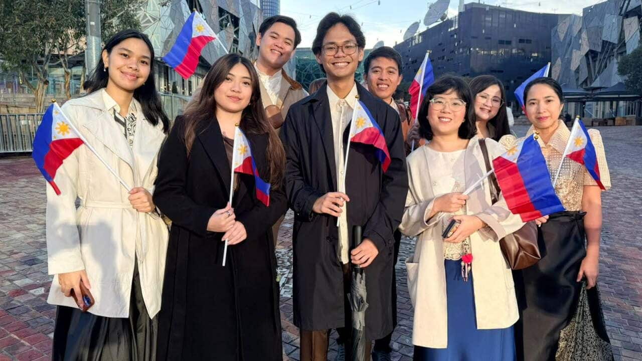 Crowds gather in Federation Square in Melbourne this morning, awaiting the raising of the Philippine flag to celebrate the 128th Philippine Independence Day.