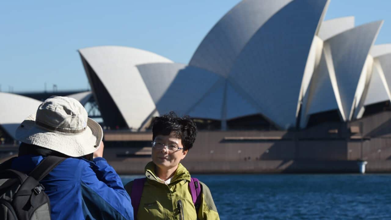 Chinese tourists take in the sites of Sydney Harbour