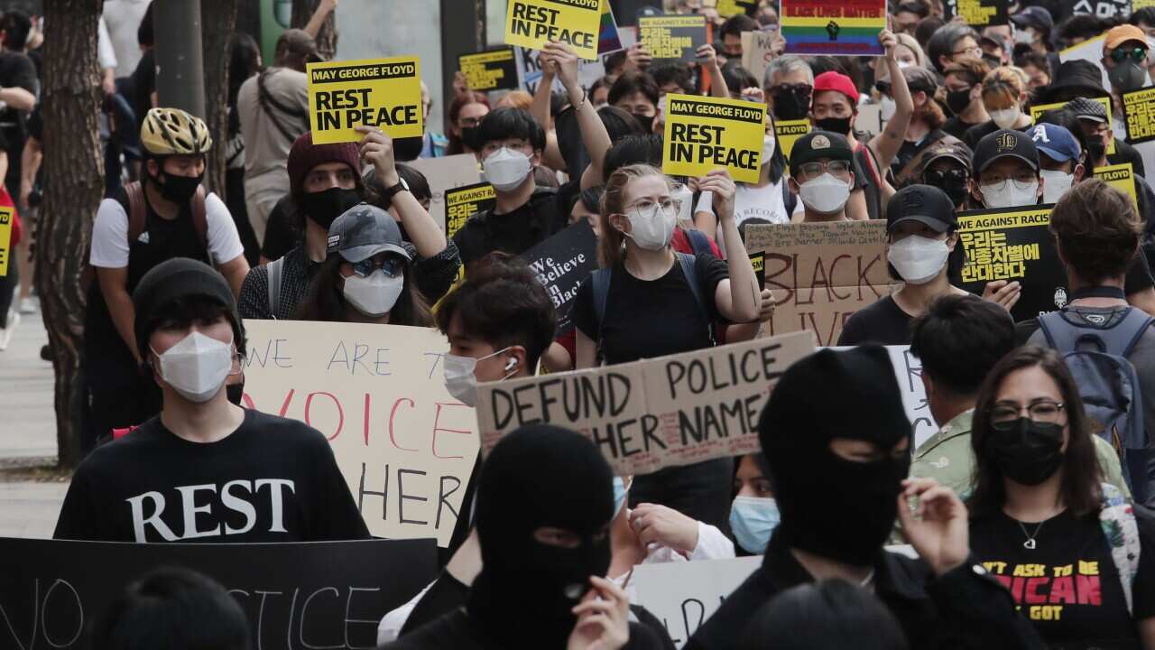 People march to protest during a solidarity rally for the death of George Floyd in Seoul, South Korea, Saturday, June 6, 2020. Floyd died after being restrained by Minneapolis police officers on May 25.(AP Photo/Ahn Young-joon)
