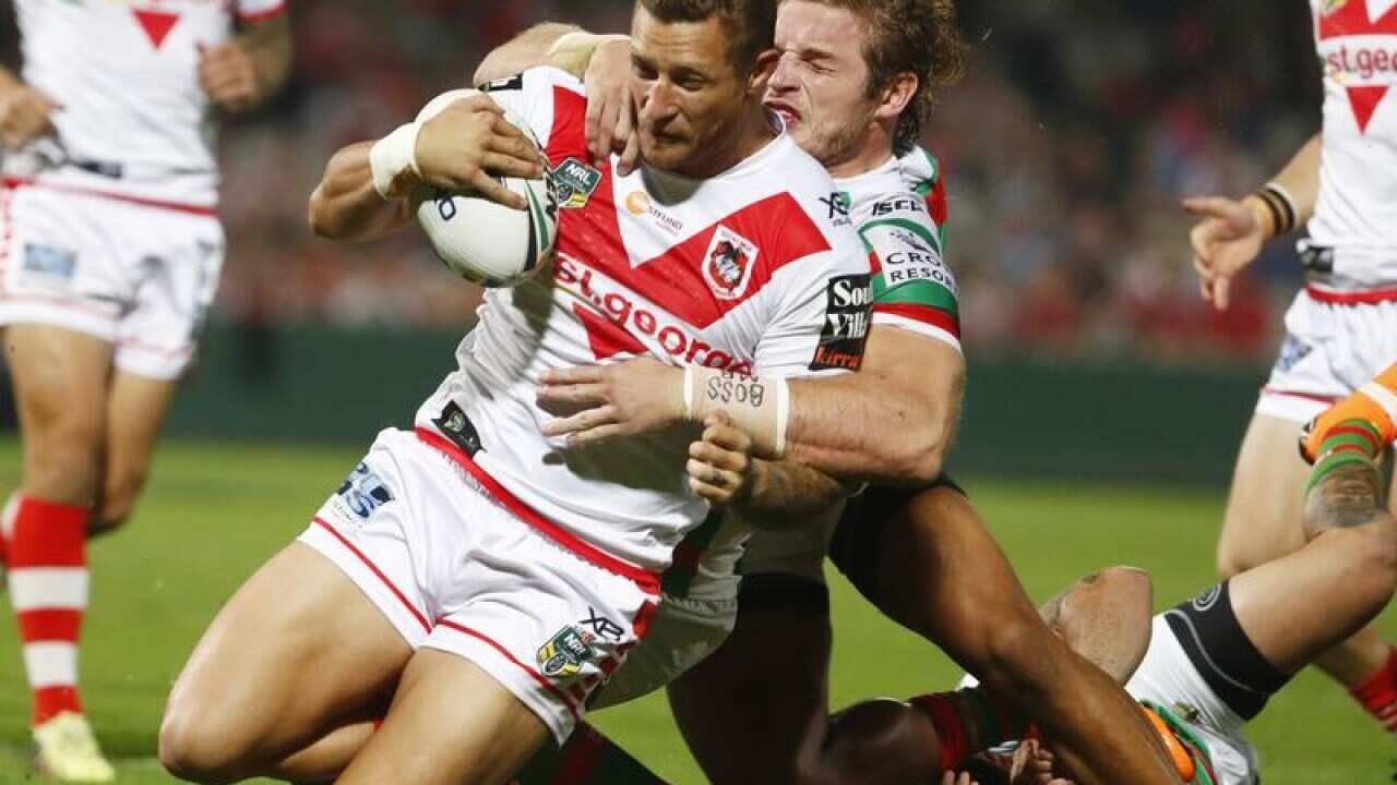 Tariq Sims of the Dragons is tackled against the Rabbitohs.