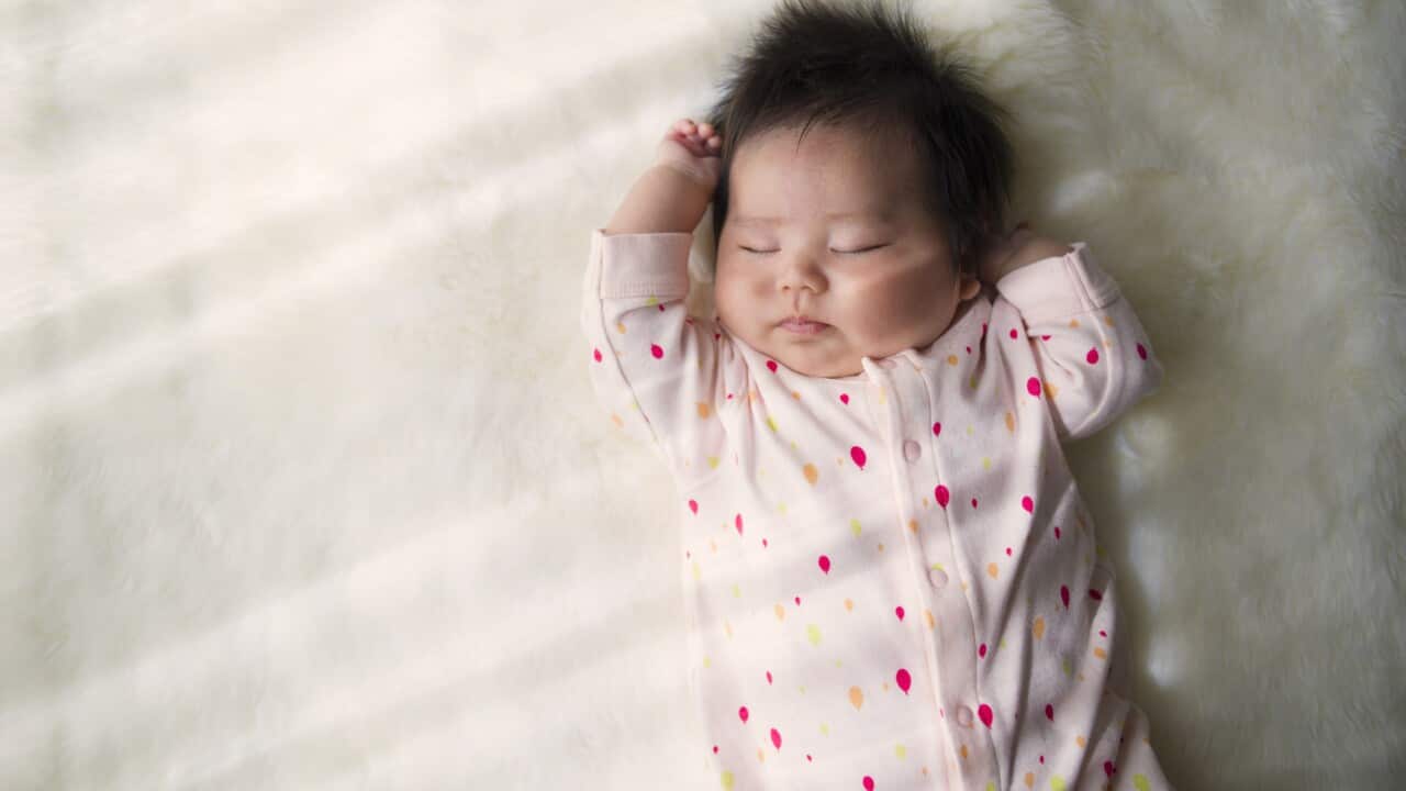 Baby girl sleeping at home.