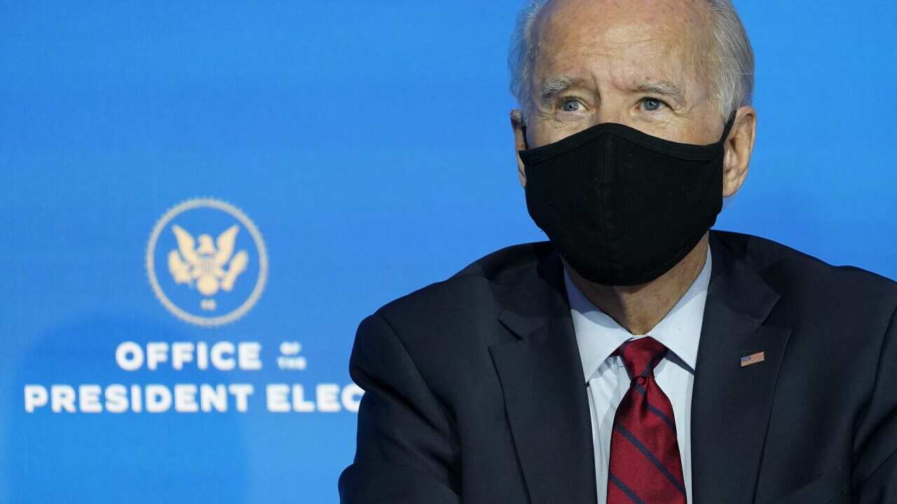 President-elect Joe Biden listens during an event at The Queen theater in Wilmington, Del., Tuesday, Dec. 8, 2020, to announce his health care team. (AP Photo/Susan Walsh)