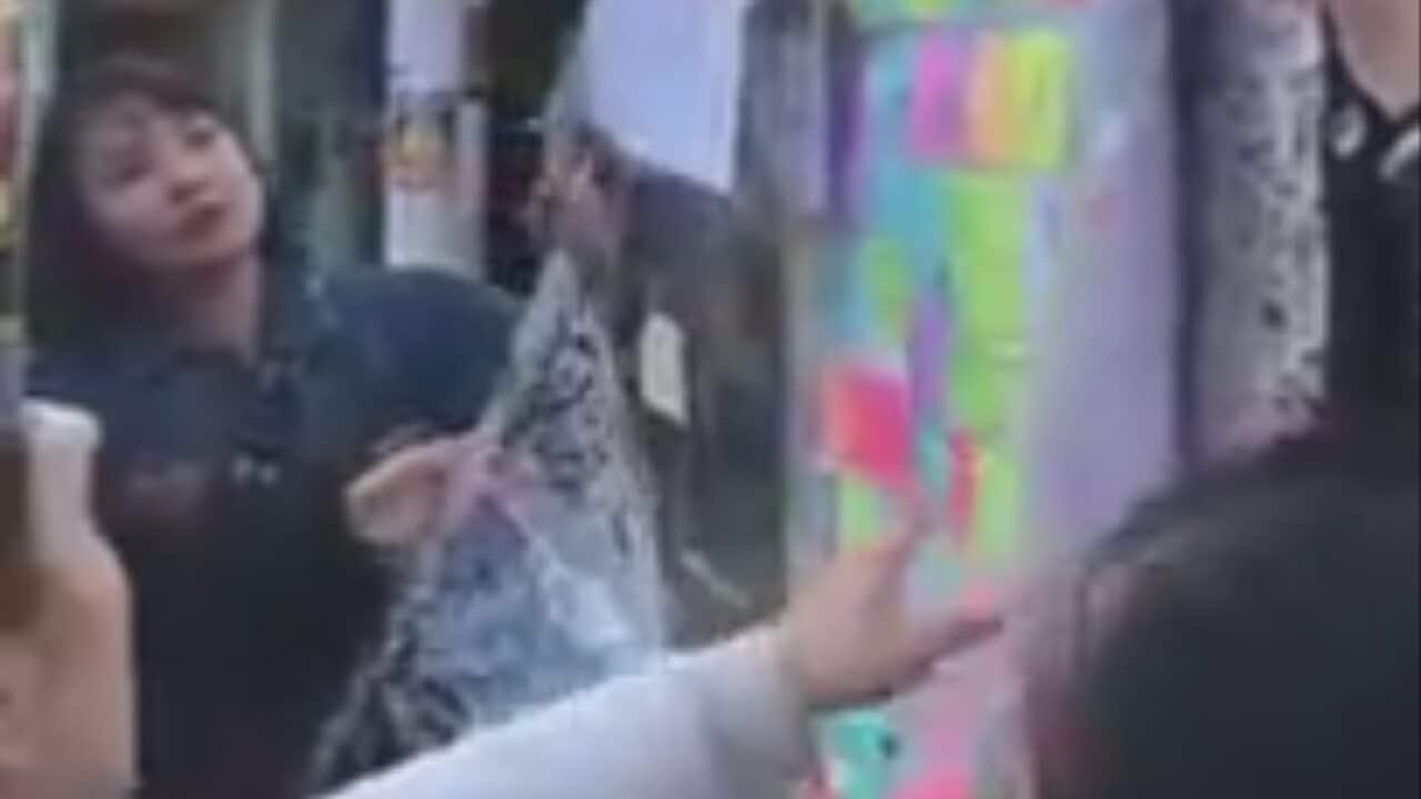Protesters tear down a pro-Hong Kong 'Lennon wall' at the University of Sydney.