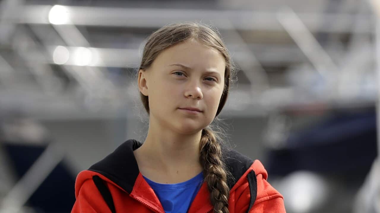 Greta Thunberg walks in the Marina where the boat Malizia is moored, in Plymouth, England Tuesday, Aug. 13, 2019.