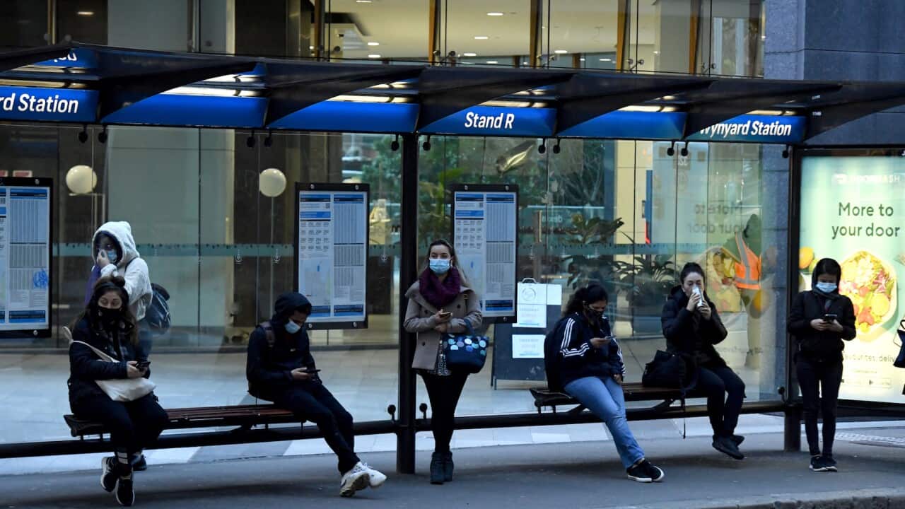 Commuters wait for buses at Wynyard railway station in the central business district in Sydney, Tuesday, July 20, 2021