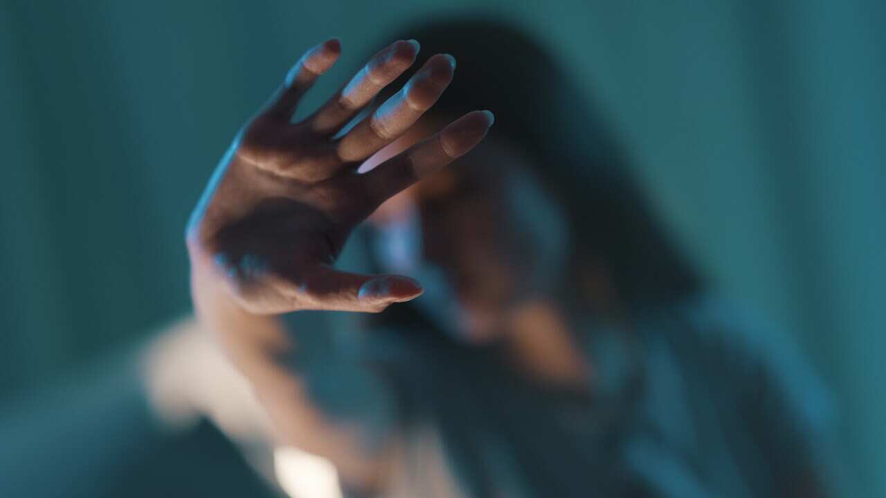 Young woman doing a stop sign with her hand
