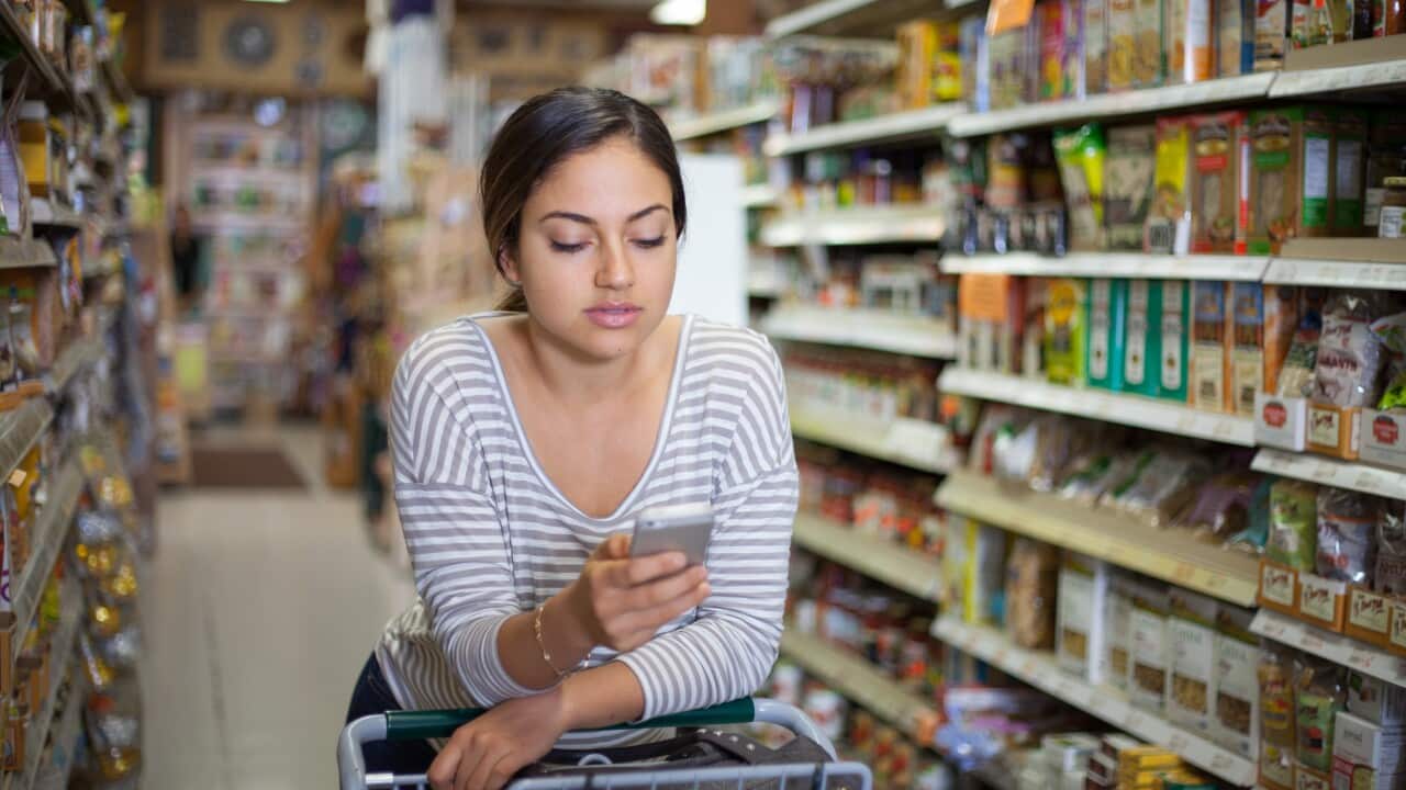 Young woman shopping with in food store.