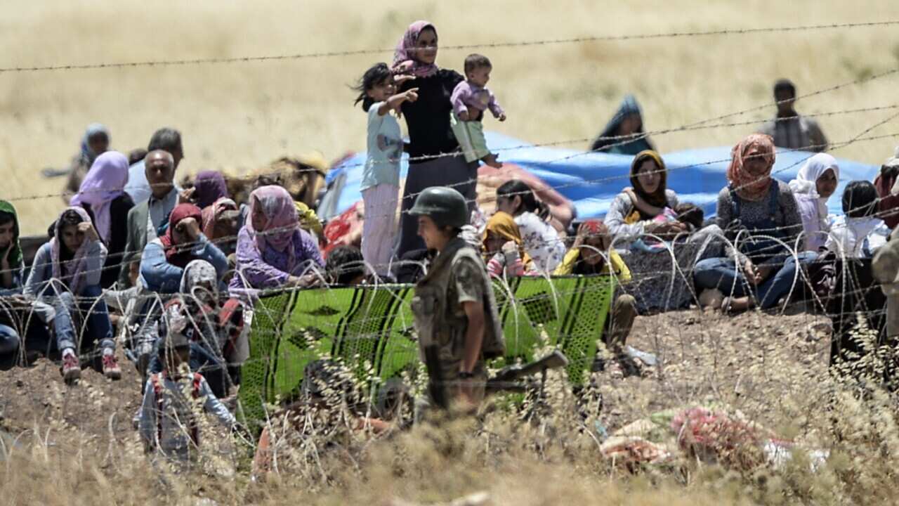 Syrian refugees waiting to enter Turkey.