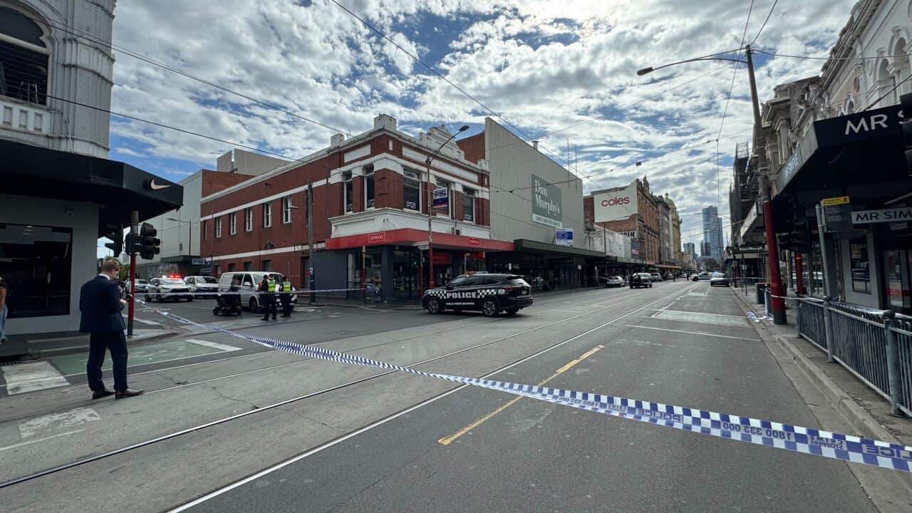 A street is lined off with police tape.