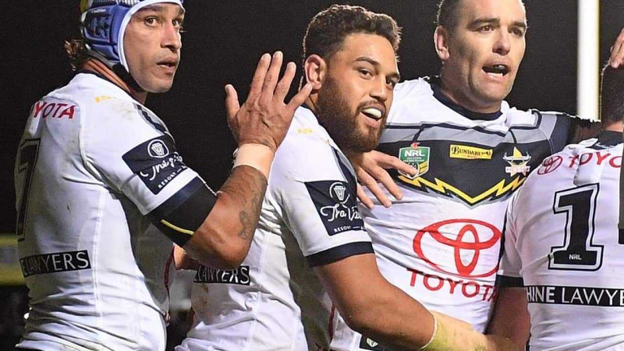 Johnathan Thurston celebrates a try with Cowboys teammates.