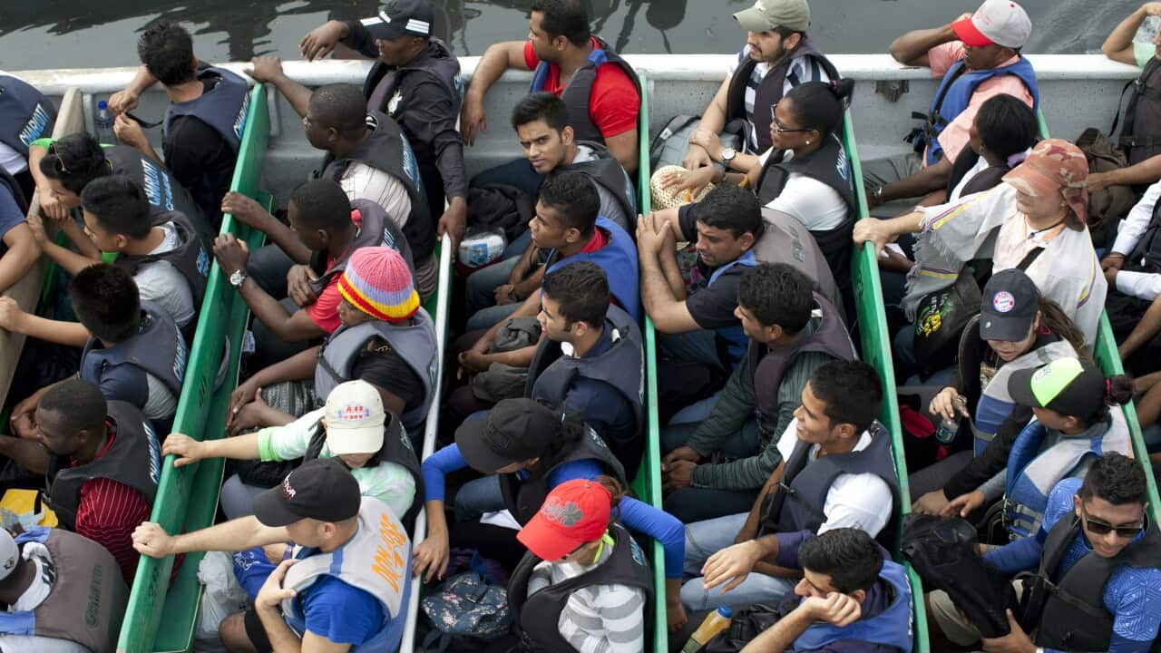 A boat full of migrants awaits transportation in the Colombian port town, Turbo.