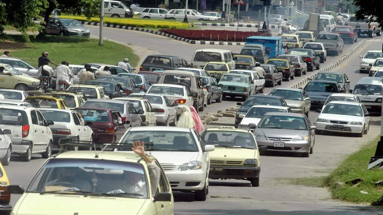 Pakistani commuters sit in their vehicle