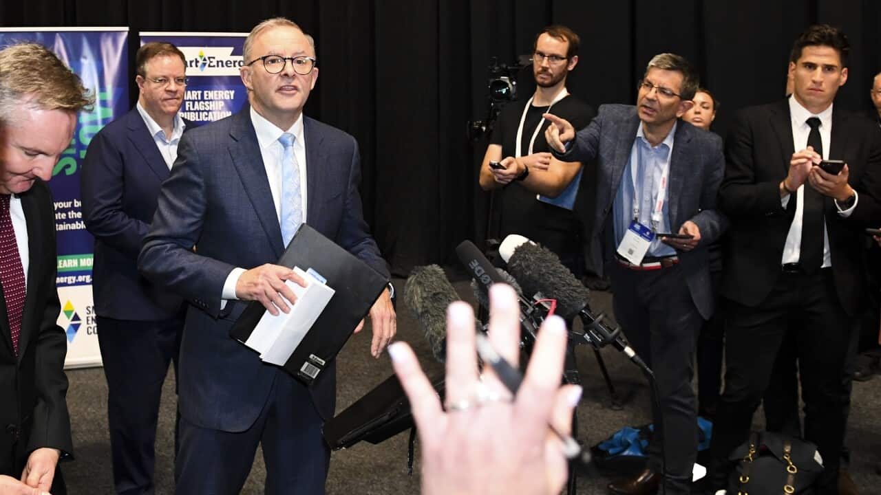 Australian Opposition Leader Anthony Albanese holds his briefings folder as he leaves after speaking to the media during a visit to the Smart Energy Council Conference and Exhibition on Day 25 of the 2022 federal election campaign