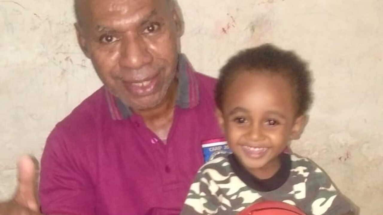 Timotius Kambu.relaxes with his grandchild.