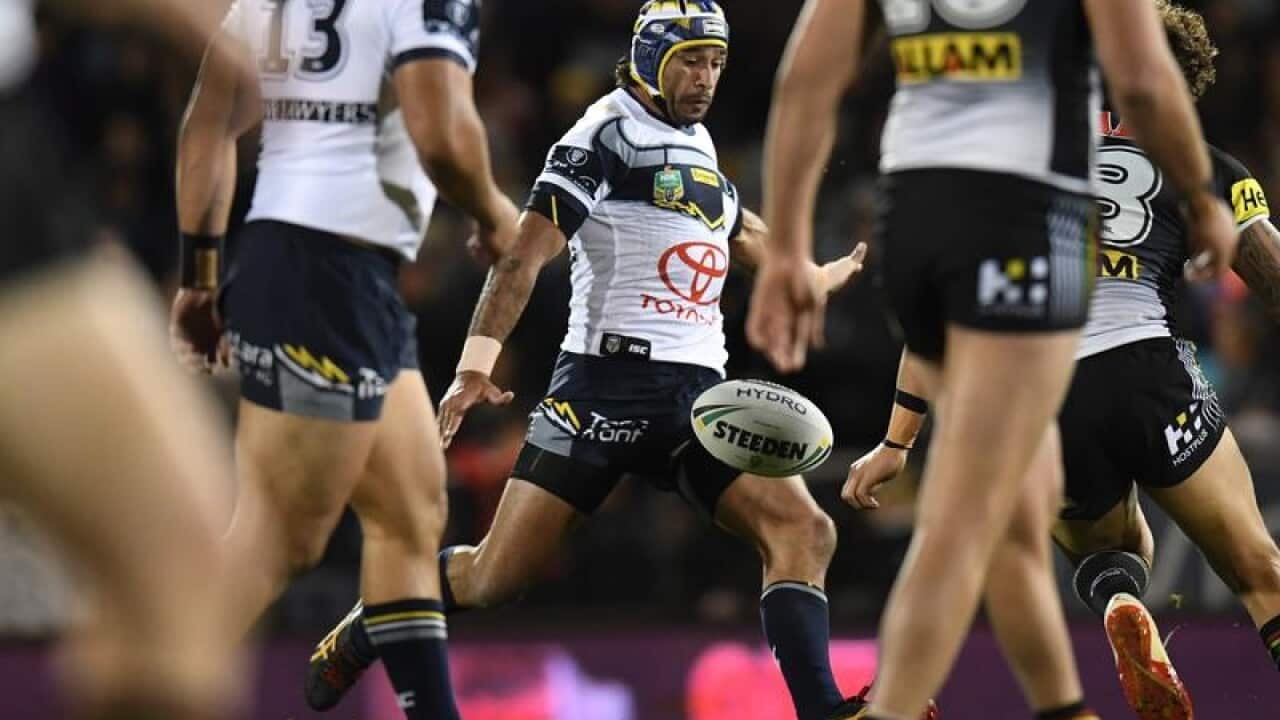 Johnathan Thurston of the Cowboys takes a kick.
