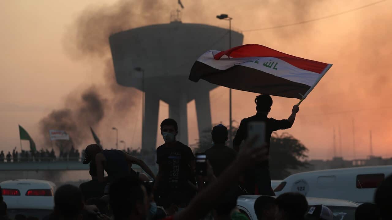 Anti-government protesters wave flags during a demonstration in Baghdad, Iraq, Wednesday, Oct. 2, 2019. Iraqi officials said several protesters have been killed Wednesday and scores injured amid gunfire and clashes in Baghdad. (AP Photo/Hadi Mizban)