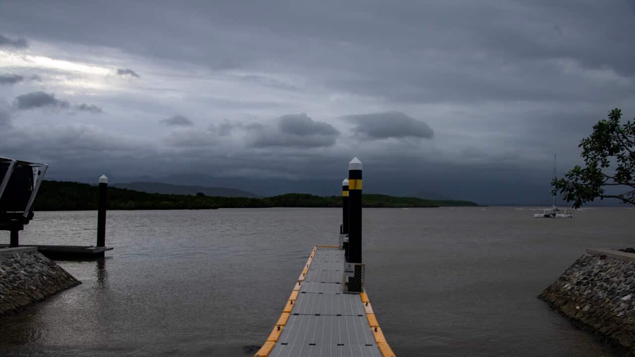 Grey storm clouds above a body of water.