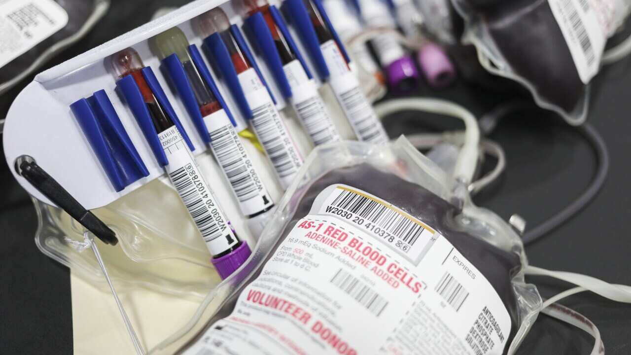 Vials of blood for testing and a donated bag of blood at an American Red Cross blood drive