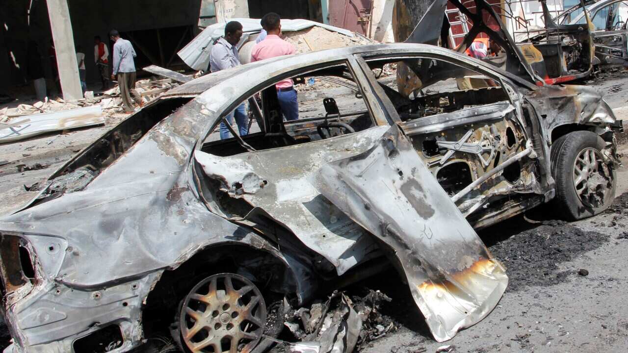 Damaged vehicles are seen after a car bombing near the Somali parliament building.