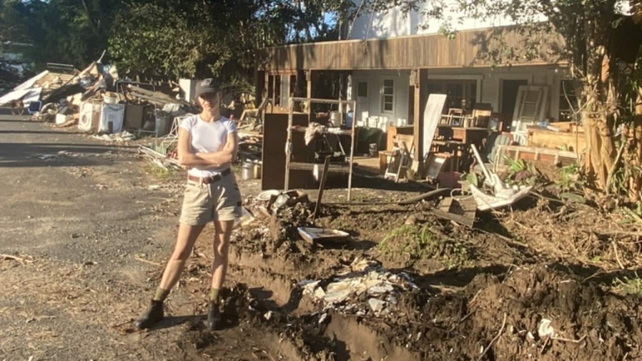 Mardi Wilson outside a Lismore home she helped to clean up