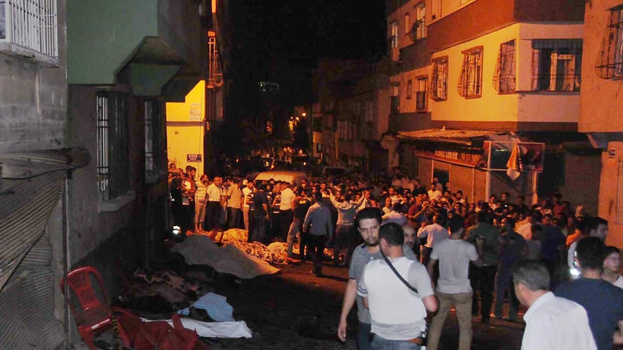 People gather after an explosion in Gaziantep, southeastern Turkey, early Sunday, Aug. 21, 2016. Gaziantep Province Gov. Ali Yerlikaya said the deadly blast, during a wedding near the border with Syria, was a terror attack. (Eyyup Burun/DHA via AP)e