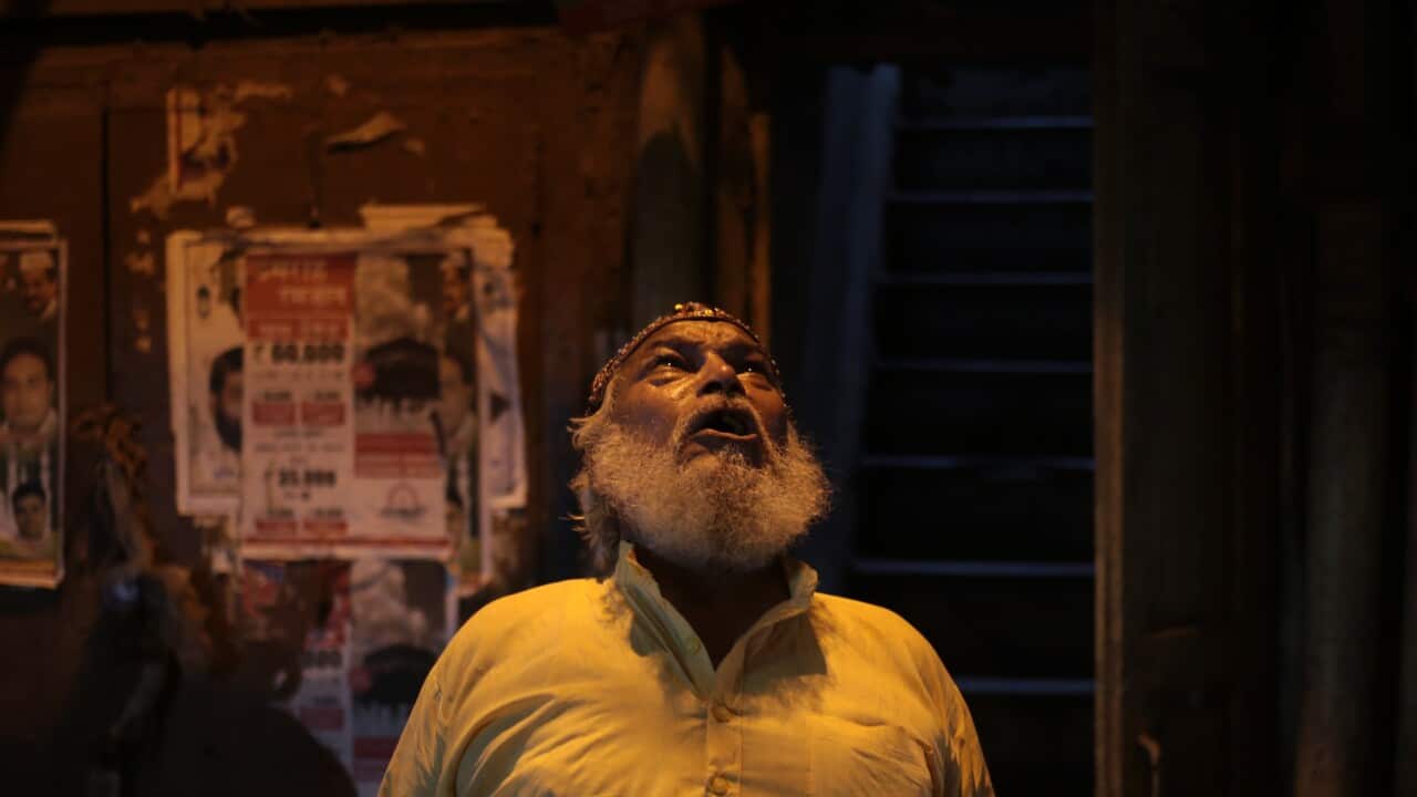 Mohammed Shafiq, a town crier, shouts out to neighbors by name to wake them for a pre-dawn meal during Ramadan in the Old Delhi quarter of New Delhi.